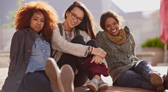 portrait female student floor campus break relax classes university face happy diverse friends school education women learners academics learning college