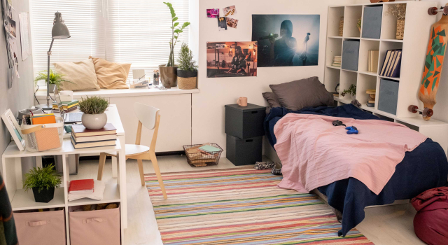 spacious bedroom teenage student with bed desk with lamp laptop other stuff